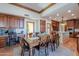 Elegant dining area with wood table, trim, cabinetry, and an island, blending classic design at 1520 E Elmwood Cir, Mesa, AZ 85203