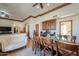 Open concept dining area with a large wooden table, hardwood floors, and a white tufted sofa at 1520 E Elmwood Cir, Mesa, AZ 85203