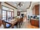 Open concept dining area with a large wooden table, hardwood floors, and stylish decor at 1520 E Elmwood Cir, Mesa, AZ 85203