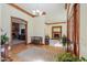 Grand foyer featuring wood trim, hardwood floors, an accent rug, and views into the living room at 1520 E Elmwood Cir, Mesa, AZ 85203