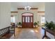 Elegant foyer with hardwood floors, a chandelier, and detailed trim work, creating a grand entrance at 1520 E Elmwood Cir, Mesa, AZ 85203