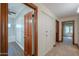 Hallway leading to the bathroom, with built-in cabinetry for plenty of storage and a glimpse into the shower area at 1520 E Elmwood Cir, Mesa, AZ 85203