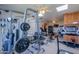 Home gym featuring weightlifting equipment, treadmill, and exercise bike at 1520 E Elmwood Cir, Mesa, AZ 85203