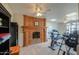Home gym with brick fireplace, drop ceiling, and exercise equipment at 1520 E Elmwood Cir, Mesa, AZ 85203