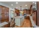 Spacious kitchen with a center island, wood cabinetry, granite countertops, and stainless appliances at 1520 E Elmwood Cir, Mesa, AZ 85203