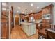 Spacious kitchen featuring a center island, wooden cabinetry, granite countertops, and stainless appliances at 1520 E Elmwood Cir, Mesa, AZ 85203