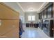 Functional laundry room with a sink, storage cabinets, and a modern washer and dryer set, designed for convenience at 1520 E Elmwood Cir, Mesa, AZ 85203