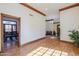 Open-concept living space featuring wood trim, hardwood floors, and views to the dining and sitting rooms at 1520 E Elmwood Cir, Mesa, AZ 85203