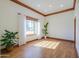 Bright living room featuring hardwood floors, large windows with sheer curtains, and wood trim at 1520 E Elmwood Cir, Mesa, AZ 85203