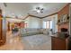Spacious living room featuring a brick fireplace, hardwood floors, and a large sectional sofa at 1520 E Elmwood Cir, Mesa, AZ 85203