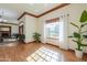 Spacious, sunny living room with hardwood floors, a fireplace, and large windows at 1520 E Elmwood Cir, Mesa, AZ 85203