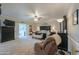 Large main bedroom with a ceiling fan, a seating area, and an ensuite bath behind double doors at 1520 E Elmwood Cir, Mesa, AZ 85203