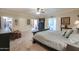 Large main bedroom featuring a ceiling fan, an ensuite bath, and hardwood doors at 1520 E Elmwood Cir, Mesa, AZ 85203