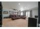 Spacious media room featuring a large brown leather sectional sofa, movie posters, and access to the backyard at 1520 E Elmwood Cir, Mesa, AZ 85203