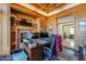 Cozy office with wood paneling, a fireplace, built-in shelves, and detailed trim at 1520 E Elmwood Cir, Mesa, AZ 85203