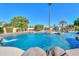 Stunning pool with waterfall feature perfect for relaxation and recreation at 1520 E Elmwood Cir, Mesa, AZ 85203