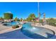 Luxurious backyard pool with a spa, waterfall feature, and professionally landscaped surroundings at 1520 E Elmwood Cir, Mesa, AZ 85203