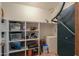 Organized storage room with shelving, various storage containers, and a cleaning appliances at 1520 E Elmwood Cir, Mesa, AZ 85203