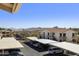 Scenic view from a condo balcony overlooking covered parking and desert landscape with mountains in the distance at 16615 E Gunsight Dr # 205, Fountain Hills, AZ 85268