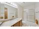 Bright bathroom with a granite vanity, framed mirror and shower-tub combo at 16615 E Gunsight Dr # 205, Fountain Hills, AZ 85268