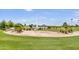 Community space with a unique star-shaped design, lush greenery, and a serene lake backdrop at 16615 E Gunsight Dr # 205, Fountain Hills, AZ 85268