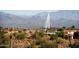 Desert landscape showcasing homes nestled among native cacti, with mountains and a fountain backdrop at 16615 E Gunsight Dr # 205, Fountain Hills, AZ 85268