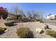 A desert landscaped yard with a brick sign and home in the background at 16615 E Gunsight Dr # 205, Fountain Hills, AZ 85268