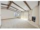 Open living room with beamed ceilings, fireplace, and lots of natural light at 16615 E Gunsight Dr # 205, Fountain Hills, AZ 85268