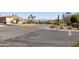 Wide street view showcasing the community's palm trees, desert landscaping, and mountain views at 16615 E Gunsight Dr # 205, Fountain Hills, AZ 85268