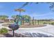 Community playground featuring a shaded play structure, slide, and grill, perfect for outdoor fun at 17152 W Oberlin Way, Surprise, AZ 85387