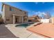 Private in-ground swimming pool with a wood deck and covered patio with lush landscaping at 17254 W Marshall Ln, Surprise, AZ 85388