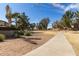 Expansive community lawn with sidewalk, trees and lush landscaping, perfect for recreational activities and neighborhood gatherings at 17254 W Marshall Ln, Surprise, AZ 85388