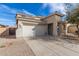 Exterior view of home featuring a two-car garage, front porch, and desert landscaping at 17254 W Marshall Ln, Surprise, AZ 85388