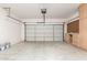 Spacious two car garage features built in shelving with an automatic door opener at 17254 W Marshall Ln, Surprise, AZ 85388