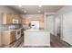 Charming kitchen featuring wooden cabinets, white appliances, and a center island at 17254 W Marshall Ln, Surprise, AZ 85388