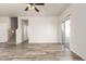 Open-concept living room with wood-look floors and sliding glass door leading to the outside at 17254 W Marshall Ln, Surprise, AZ 85388