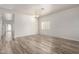 Spacious living room features wood-look flooring and a chandelier at 17254 W Marshall Ln, Surprise, AZ 85388