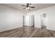 Main bedroom featuring wood-look floors, and multiple closets and ensuite entrances at 17254 W Marshall Ln, Surprise, AZ 85388