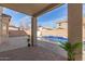 Back patio shows patterned concrete with views of the pool and private backyard at 17254 W Marshall Ln, Surprise, AZ 85388