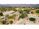 Aerial view of the home showcasing desert landscaping, surrounding golf course and mountain views at 18419 E Agua Verde Dr, Rio Verde, AZ 85263