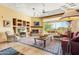 Bright open concept living room with beamed fireplace, built in shelving, and views of the back yard at 18419 E Agua Verde Dr, Rio Verde, AZ 85263