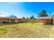Expansive backyard featuring a covered patio and an additional outbuilding for storage or hobbies at 1926 E Clarendon Ave, Phoenix, AZ 85016