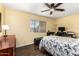 Bedroom features light yellow walls, hardwood floors, a ceiling fan, and a small workspace at 1926 E Clarendon Ave, Phoenix, AZ 85016