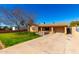 Charming single-story home with well-manicured lawn and driveway, under a clear blue sky at 1926 E Clarendon Ave, Phoenix, AZ 85016