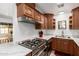 Modern kitchen with stainless steel range, granite counters, and stylish cabinets at 1926 E Clarendon Ave, Phoenix, AZ 85016