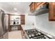 Bright kitchen with a stainless steel gas range, marble countertops, and a light wood floors at 1926 E Clarendon Ave, Phoenix, AZ 85016