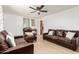 Spacious living room features modern ceiling fan, light wood floors, and multiple seating options at 1926 E Clarendon Ave, Phoenix, AZ 85016