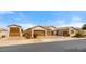 Charming single-story home with a three-car garage, well-manicured landscaping, and a welcoming front entrance at 19850 E Cattle Dr, Queen Creek, AZ 85142