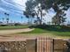 The backyard gate opens to a meticulously maintained golf course view at 2260 S Seminole Dr, Apache Junction, AZ 85119