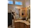Well-lit bathroom features a vessel sink, decorative mirror, and a cabinet for storage at 2260 S Seminole Dr, Apache Junction, AZ 85119